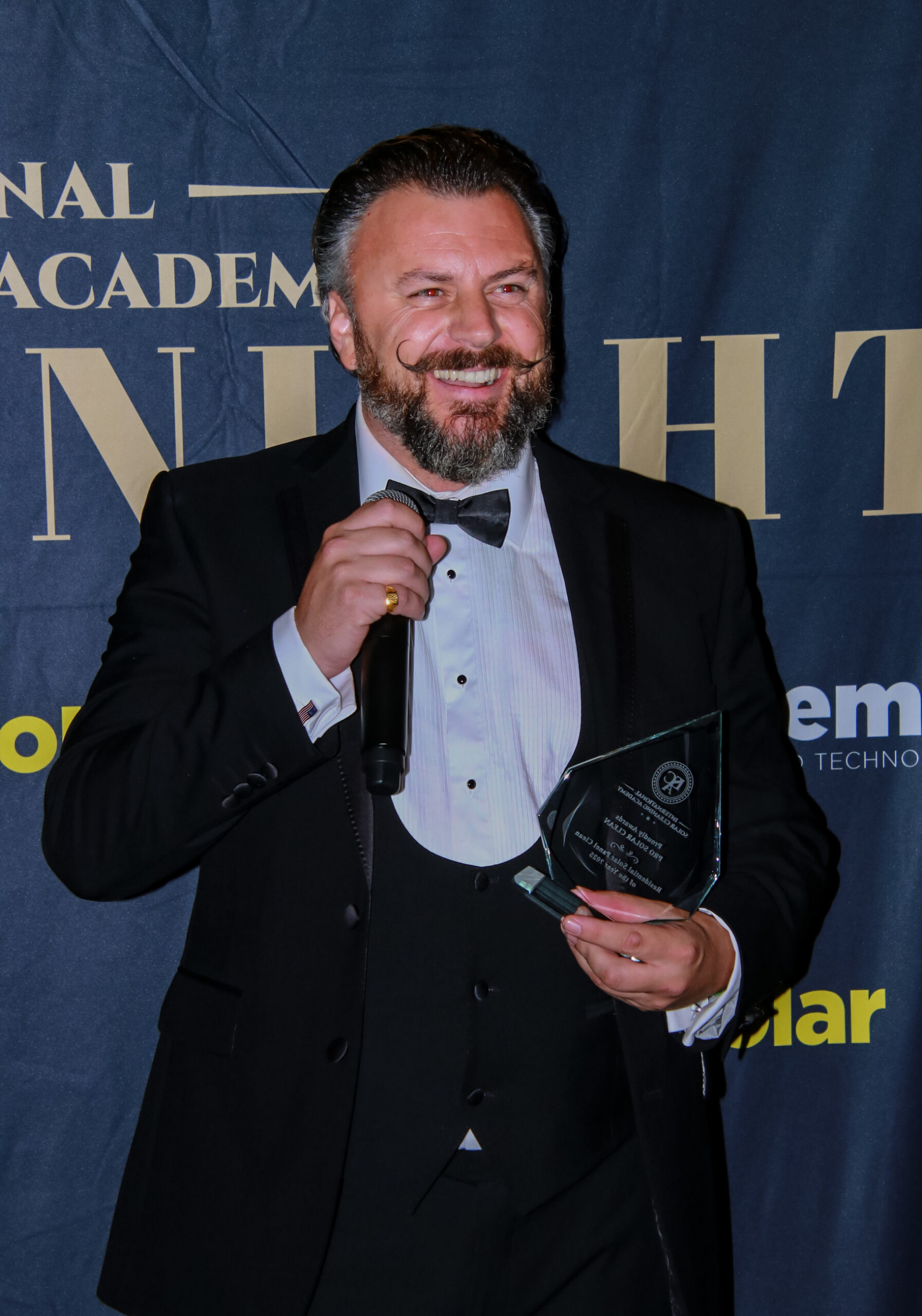 man in dinner suit receiving an award